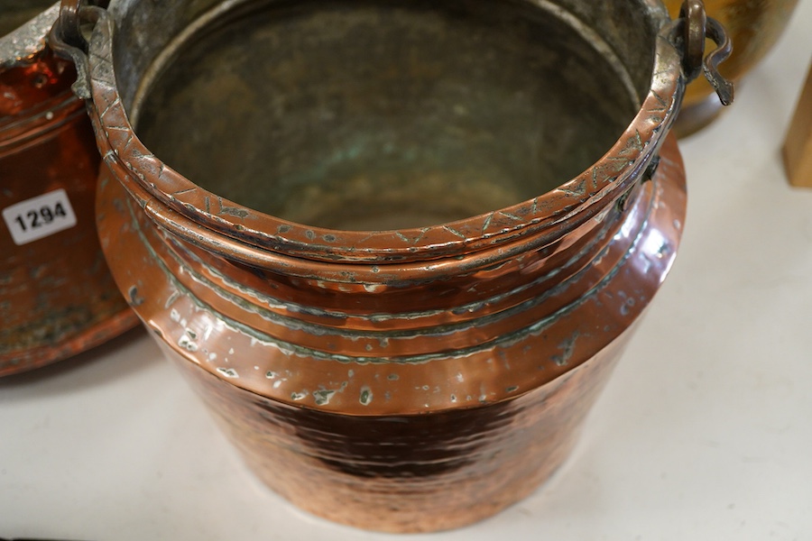 A collection of four copper vessels and another brass, largest 32cm